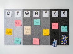 a bulletin board with sticky notes attached to it