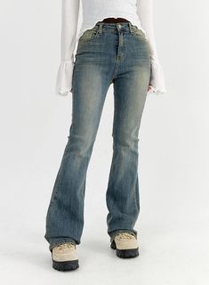 a woman in jeans is standing with her back to the camera