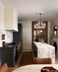 a kitchen with marble counter tops and an island in front of the stove top oven