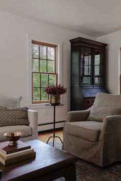 a living room filled with furniture and windows