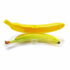 two bananas sitting next to each other in a plastic container on a white background with clippings