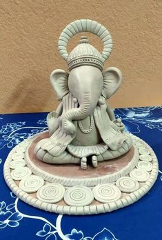 an elephant statue sitting on top of a blue table