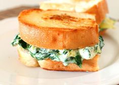 there is a sandwich with spinach and cheese on it