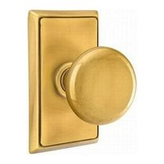 a brass plated door handle with a round knob