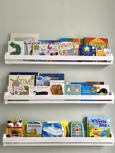 two white shelves filled with books on top of each other