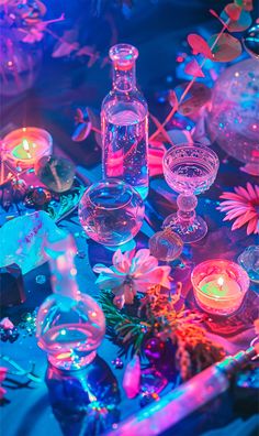 a table topped with lots of glass vases and candles