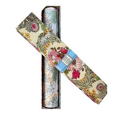 two rolls of paper with floral designs on them, one rolled up and the other rolled down