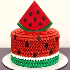 a cake made to look like a slice of watermelon on top of it