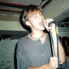 a young man singing into a microphone