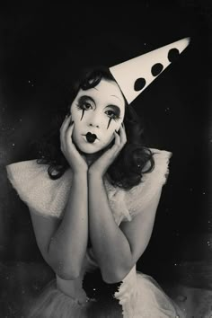 a woman wearing a party hat with her hands on her face