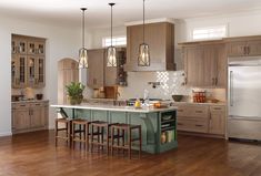 a large kitchen with wooden floors and cabinets