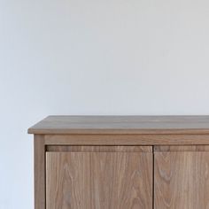 a wooden cabinet with a vase on top of it