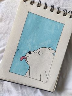 a notebook with a drawing of a polar bear sticking its tongue out to the sky