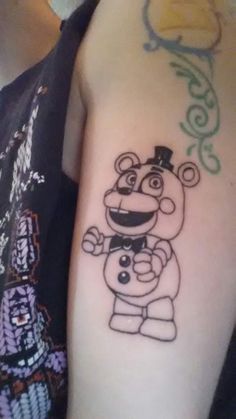 a cartoon character tattoo on the arm