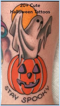 a halloween tattoo with a ghost and pumpkin on it