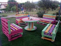 colorful wooden benches and tables in the grass