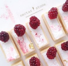 raspberries and marshmallows are arranged in squares