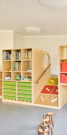 a child's playroom with toys and bookshelves