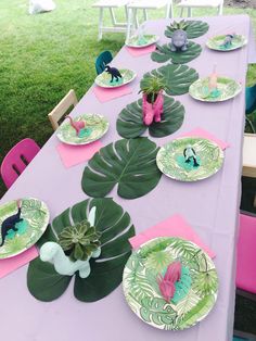 the table is set with paper plates and place settings