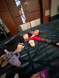 a woman laying on the floor in front of a door