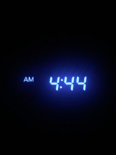 an alarm clock with the time 4 14pm on it's side in the dark