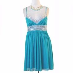 Sheer Poly, Aqua Baby Doll Mini Dress. The Bodice Has Thin Straps Running Across The Shoulders. The V Neckline Has A Silver Metallic Trim That Is Sprinkled With Sequins And The Wide Midriff Also Has The Silver Trim. The Side Ties At The Waist Connect On Backside. Full Skirt Has Lettuce Edging At The Hemline. Dress Is Lined And Slips Overhead. It Has Not Been Worn, Bears Original $89 Price Tag. (Tag Is A Little Worn) Labeled Teeze Me. Sized: S Bust: 33" Waist: 26" Hips: Full Length: 15" S-W, 2 Sheer Dress, Full Skirt, Halter Formal Dress, Baby Doll, I Dress, Lettuce, Bears, Bodice, Full Length