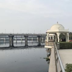 a large body of water with a bridge in the background