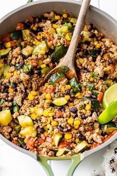 a skillet filled with ground beef, zucchini, and black bean mixture