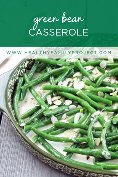 green bean casserole with almonds in a pan on a wooden table and text overlay