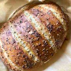 a loaf of bread sitting on top of a piece of wax paper with sprinkles