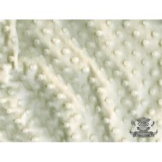 an image of a white blanket with pearls on it