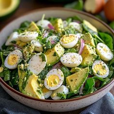 a salad with hard boiled eggs and spinach