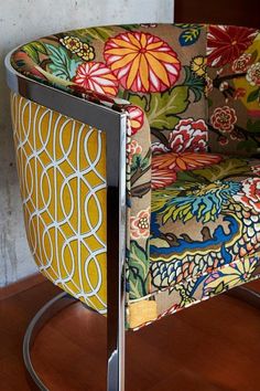 a colorful chair sitting on top of a hard wood floor