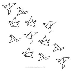 a flock of origami birds flying in the sky