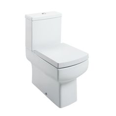 a white toilet sitting on top of a white floor