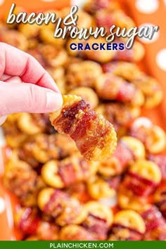 bacon and brown sugar crackers are being held up by a person's hand