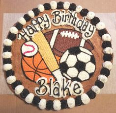 a birthday cake decorated with football, basketball and soccer ball