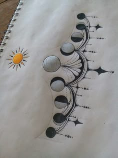 an artistic drawing on paper with the sun and moon in it's center surrounded by black dots