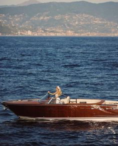 a man driving a motor boat in the ocean