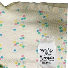 a white blanket with multicolored polka dots and the name baby morgan on it