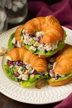 two croissant sandwiches with chicken salad on them