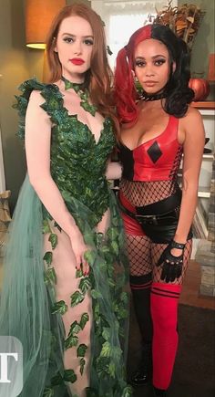 two women dressed in costumes posing for the camera