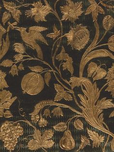 an intricately designed wallpaper with gold leaves and flowers on a black background,