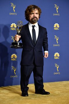 the actor poses with his award for outstanding performance in a musical