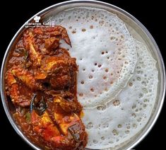 some food is in a metal bowl on a table