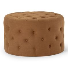 a round ottoman with buttons on the front and back legs, in brown fabric upholstered