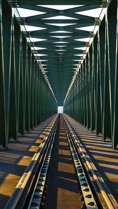 the train tracks are parallel to each other on the bridge's track cover area