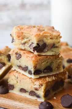 chocolate chip cookie bars stacked on top of each other next to a glass of milk