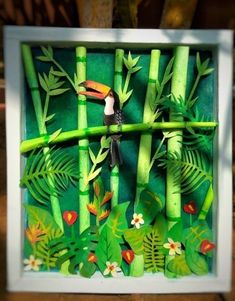 an image of a toucan in the middle of some bamboo sticks and flowers