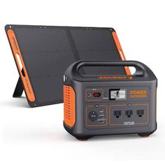 an orange and black portable solar power station with its charging box on the back side